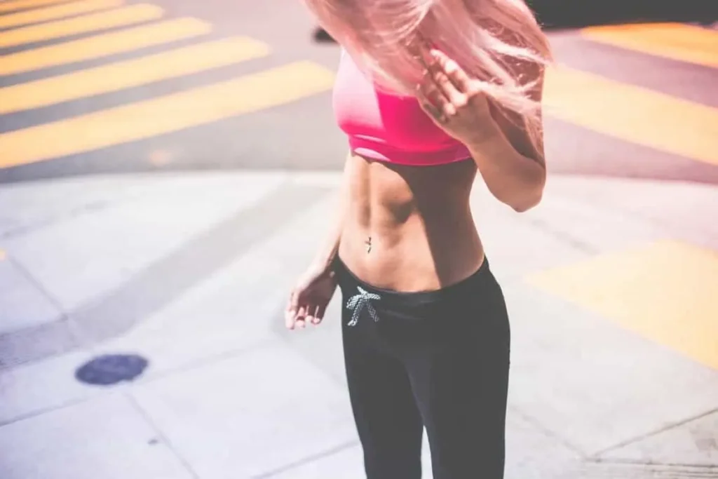 Woman with toned stomach after LA-EMS Body Sculpting Treatment Avon